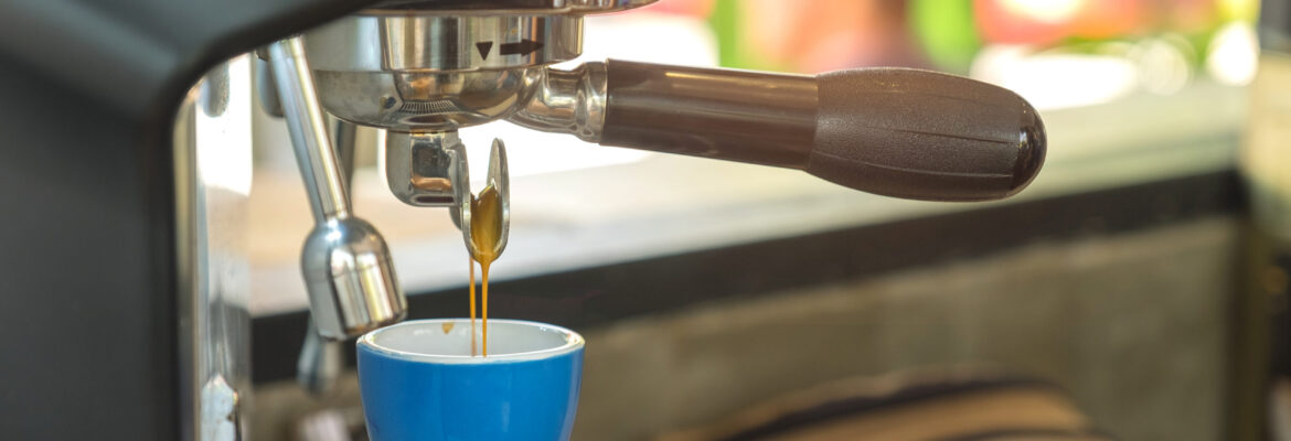 Espresso maker in blue coffee cup.